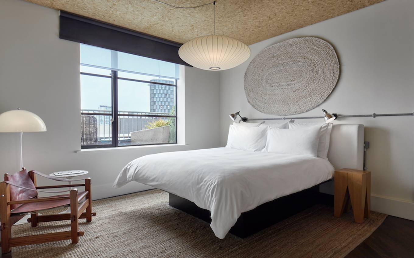 A well-decorated bedroom with a prominent round ceiling light casting a warm glow throughout the room.