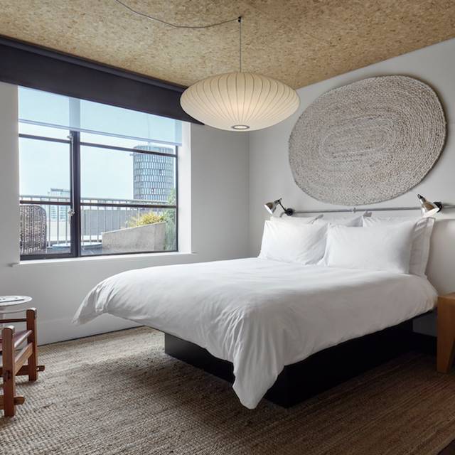 A well-decorated bedroom with a prominent round ceiling light casting a warm glow throughout the room.