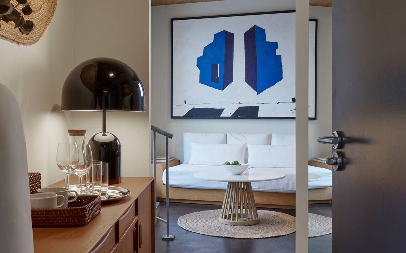 A spacious, contemporary suite at One Hundred Shoreditch with a minimalist design, offering an inviting space for relaxation.