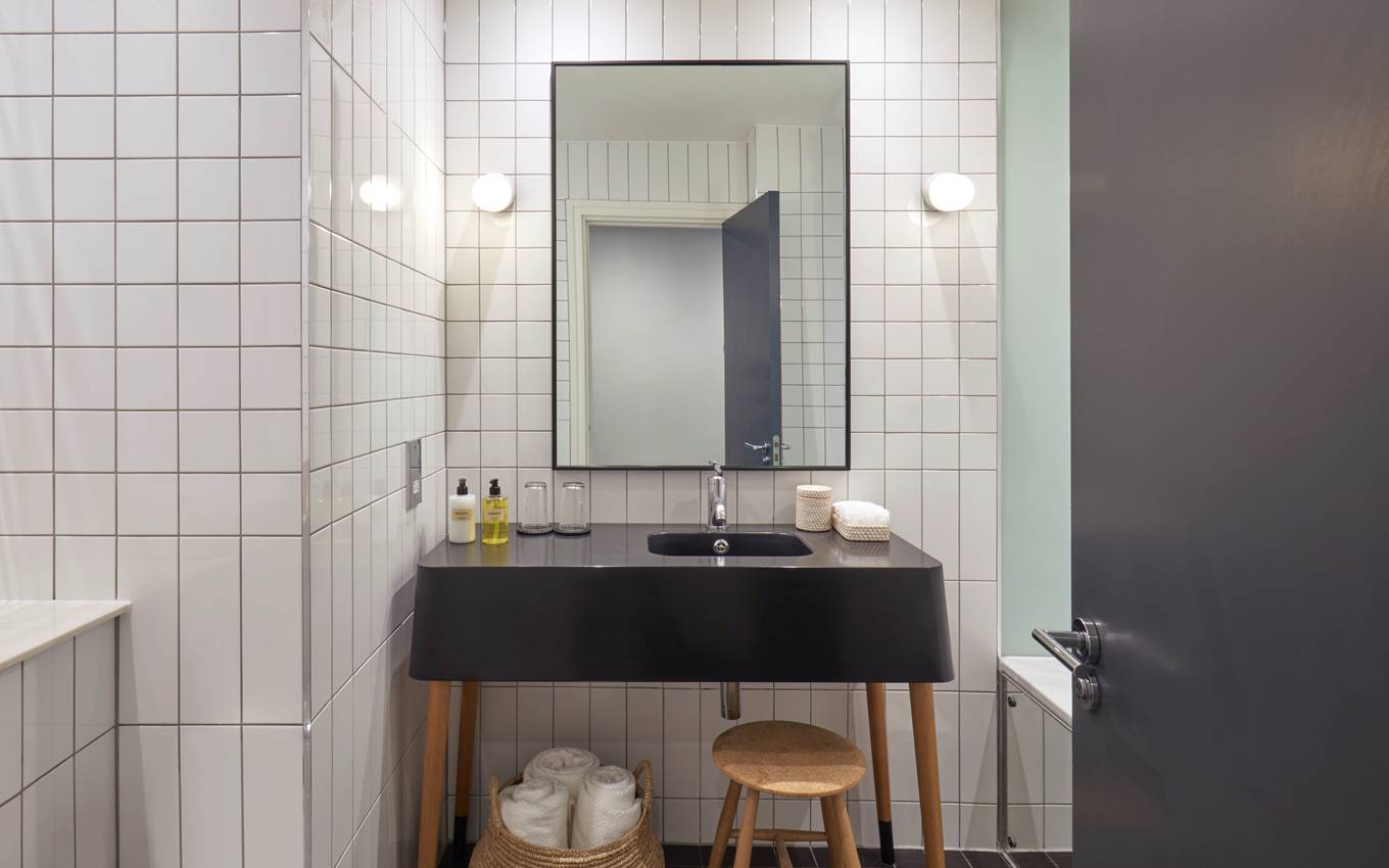 A stylish bathroom featuring a classic black and white tile floor, creating a timeless and elegant atmosphere.